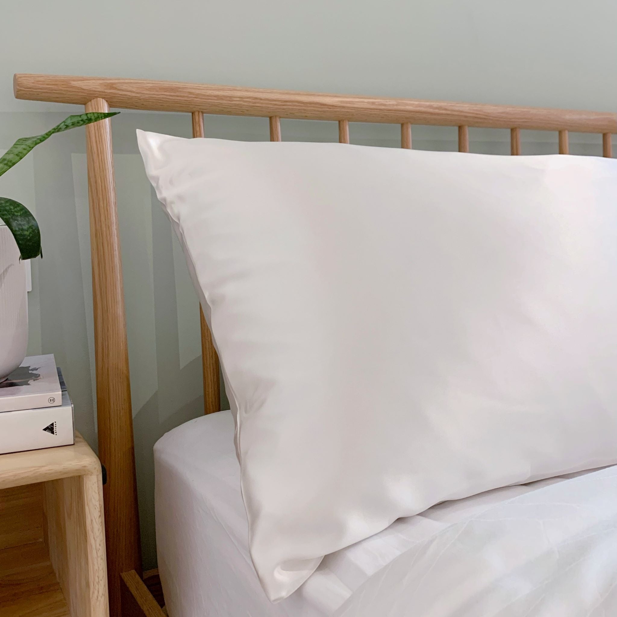 Pure mulberry silk pillowcase in Ivory White on a bed